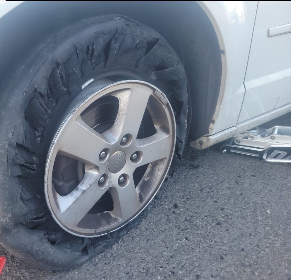 Severely damaged tire on a car